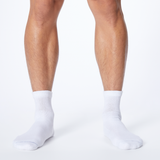 Front profile of a man wearing white Dr. Scholl's quarter socks.