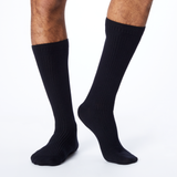 Side profile of a man wearing black, knee high Dr. Scholl's compression socks. thumbnail