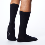 Back profile of a man wearing black Dr. Scholl's crew socks. thumbnail