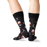 A pair of black crew socks with a pattern of whiskey glasses, cigars, and cigars being lit, shown on a person's legs against a white background. thumbnail