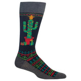 A single crew sock with a dark navy background featuring a green cactus wearing a red pot and yellow star, surrounded by festive red and green geometric patterns on the leg and foot, with a solid dark gray cuff, heel, and toe. thumbnail