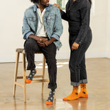 Two people wearing Halloween-themed socks in a casual setting.