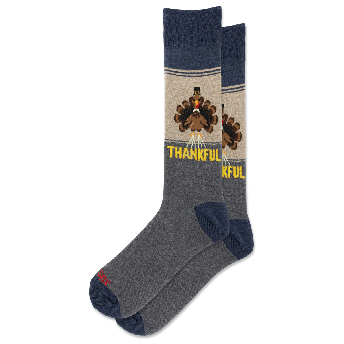 A pair of crew socks with a Thanksgiving theme. The socks feature a heather gray body, navy blue heels and toes, and a beige upper section with a cartoon turkey graphic and the word 'THANKFUL' in yellow.