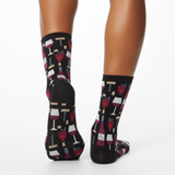 Woman wearing black socks with wine-themed pattern on a white background thumbnail