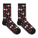 A pair of crew socks on a plain white background, featuring a black base with a repeating pattern of red wine bottles, wine glasses, corkscrews, and red raspberries. thumbnail