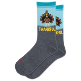 A pair of crew socks with a Thanksgiving theme. The lower half is dark heather gray, while the upper half is light blue and features a cartoon turkey wearing a black top hat with a red band, above the word 'THANKFUL' in yellow.
