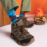 Brown hiking boots with blue socks worn, against an orange and white background. thumbnail
