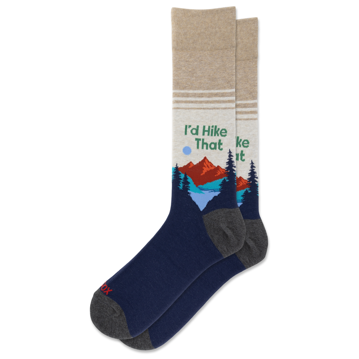 A pair of crew socks with a dark navy blue lower half, gray heels and toes, and a beige upper half featuring a graphic of mountains, pine trees, and the text 'I'd Hike That'.