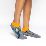 Gray and orange socks with a design inspired by 'The Scream' by Edvard Munch. thumbnail