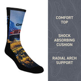 Sock with scenic design on a white background, featuring text about sock features.