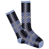 Pair of black, blue, and white patterned socks on a white background