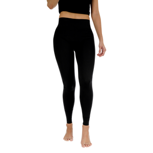 Person wearing black leggings on a white background