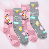 Four pairs of socks with dog and crystal designs on a pink background