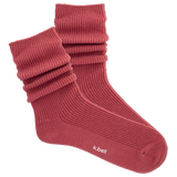 Red ribbed women's slouch sock on a white background