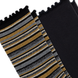 A close-up of a pair of black socks with one sock featuring horizontal stripes in black, gray, white, and shimmering gold, and the other sock is solid black, set against a plain white background.