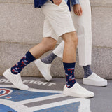 Two people wearing patterned socks and white sneakers on a street.