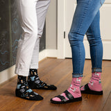 Two people wearing socks with medical and animal patterns on a wooden floor.