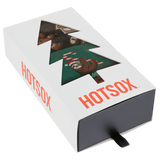 Three pairs of Christmas-themed socks in a 'HOTSOX' box on a white background