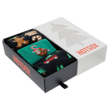 Three pairs of Christmas-themed socks in a 'HOTSOX' box on a white background