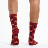 Red socks with floral pattern worn by a person on a white background thumbnail