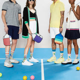 Four people standing on a pickleball court with colorful bags and socks.