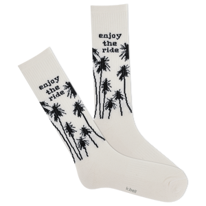 White socks with black palm tree designs and 'enjoy the ride' text on a white background