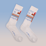 White socks with colorful text and design on a light blue background