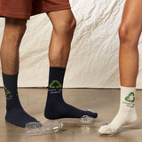 Two pairs of socks with recycling logos on a neutral background