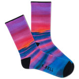 Two people wearing matching outfits with colorful socks in a casual setting.