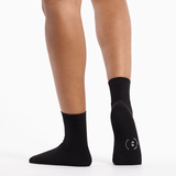 Black socks worn by a person on a white background thumbnail