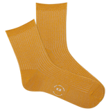 Pair of metallic gold socks with a K.Bell  logo on a white background