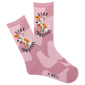 A pair of pink crew socks with a camouflage pattern and a cartoon depiction of a dog. The text 'stay pawsitive' is also featured on the socks.