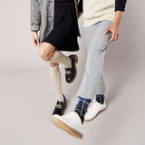 Two people wearing different styles of socks with a neutral background thumbnail