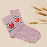 Pink sock with floral design and text on a beige background thumbnail