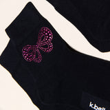 Black socks with a rhinestone bow design and 'k.bell' branding. thumbnail