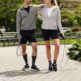 Two people walking with jump ropes in a park setting thumbnail