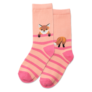 Person wearing pink and beige striped socks with fox designs on a gray floor.